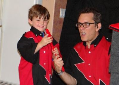 The birthday child helping magician Brian Hoffman